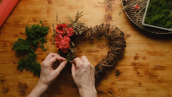 Female Hands Decorates Floral Wreath