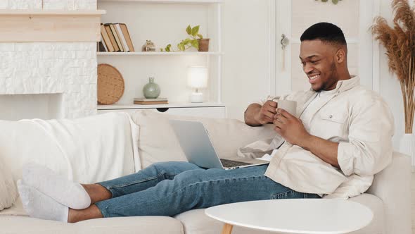 Young African Adult Ethnic Guy Student Afro Black Man Male Freelancer Sitting Lying on Living Room