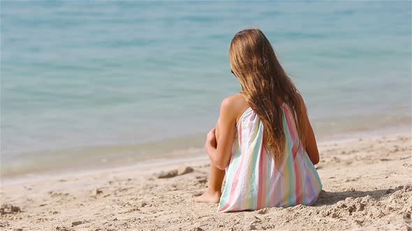 Little Adorable Girl Playing on Beach with Ball