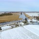 Windmill on snow covered field by canal, Lexmond, Utrecht, Netherlands - VideoHive Item for Sale