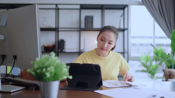 young adult asian female working at home tele conference meeting