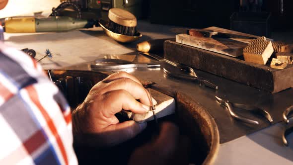 Goldsmith working in workshop