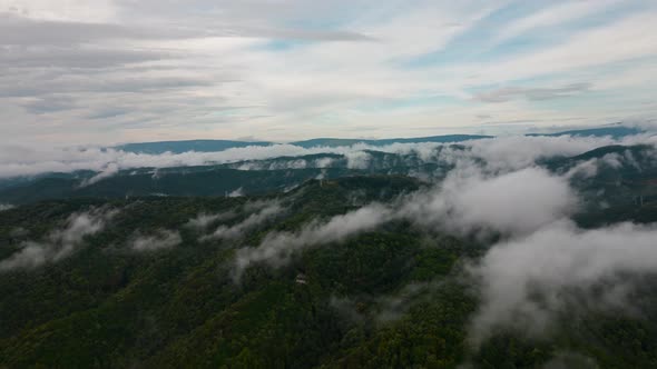 Aerial time lapse of fog over hills after rain