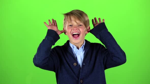 Child Is Making Grimaces. Green Screen. Slow Motion