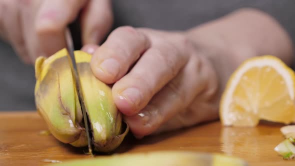 Woman Cut Artichoke