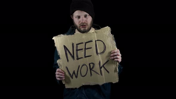 Homeless Holds Piece of Cardboard with Inscription Need Work