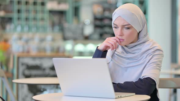 Arab Woman Thinking and Working on Laptop 