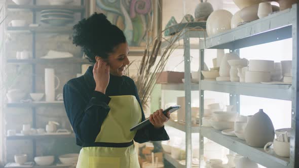 Woman Is Completing Online Order In Pottery Warehouse