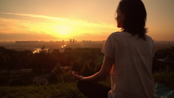 A Woman and Her Dog Are Watching the Sunrise