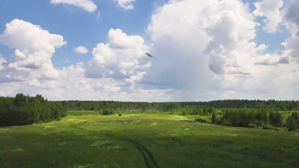 Wideangle Panorama of a Blue Sky with Clouds Over a Green Field