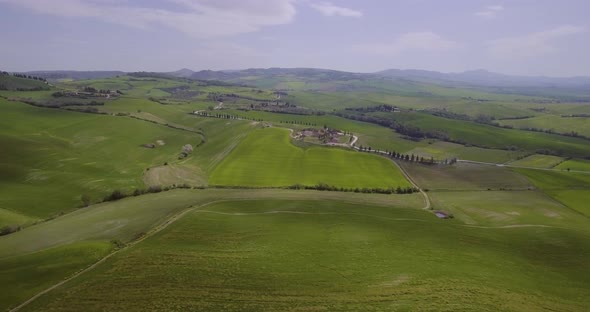 Beautiful Green Hills And Fields And Cypresses Landscape In Tuscany, Italy