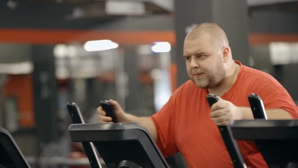 Big Sweaty Man Is Workout at Fitness Club in Orange Sportswear Clothes