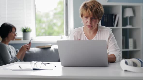 Women Using Gadgets at Home