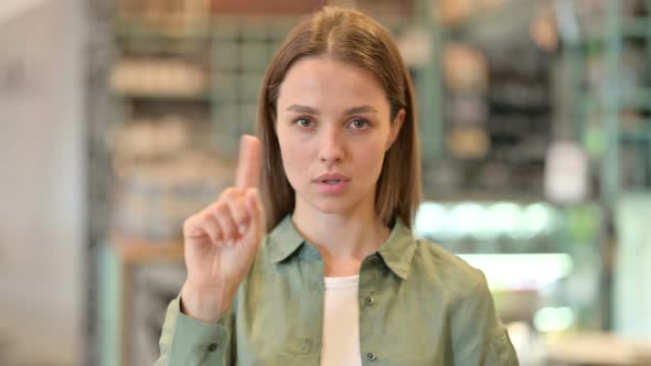 Portrait of Serious Woman Saying No By Finger Sign