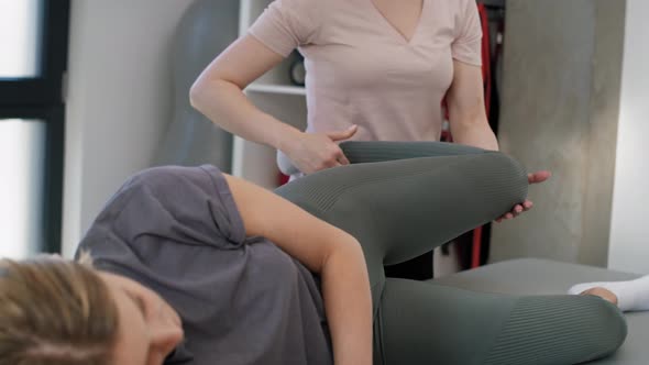 Female physical therapist helping her patient. Shot with RED helium camera in 8K.