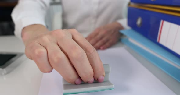 Female Hands Put a Stamp Approved on a Paper