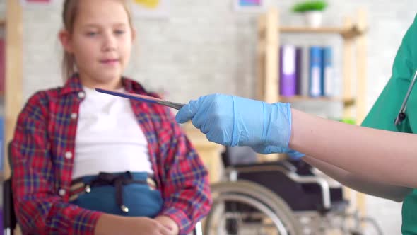 Orthopedic Doctor Tells a Teenage Girl About Orthopedic Insoles Close Up Slow Mo