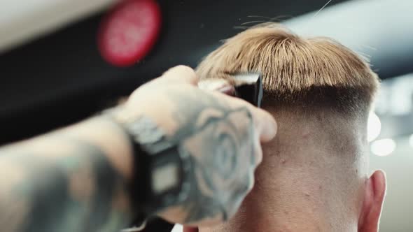 Hairdresser Makes Haircut To the Client