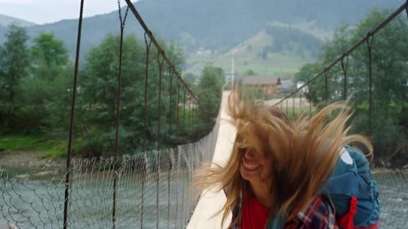 Tourist Jumping Mountain Bridge on Holiday Tour