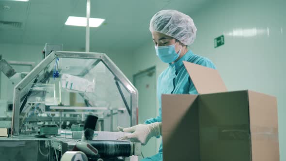 Asian Ethnicity Laboratory Worker Packs Tubes Into Boxes.