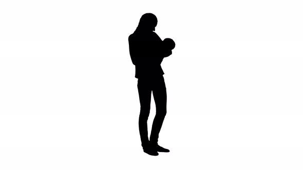 Silhouette Mother Gives Baby To Drink From Bottle