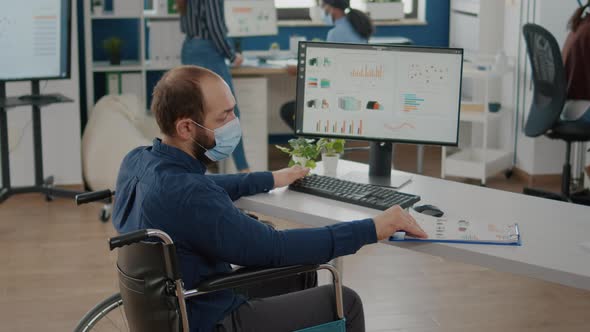 Paralyzed Man and Teamworkers Working in New Normal Office