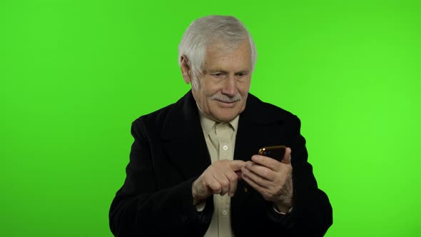 Elderly Stylish Caucasian Grandfather Man Using Smartphone for Online Shopping