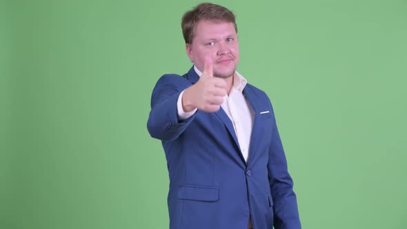 Happy Overweight Bearded Businessman Giving Thumbs Up