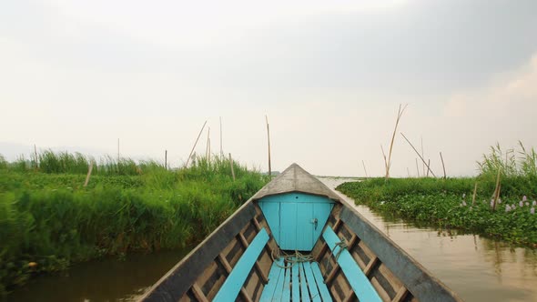 Old Blue Wooden Motor Boat Floats on the Calm River Water Surface Early Morning. Inle Lake, Myanmar