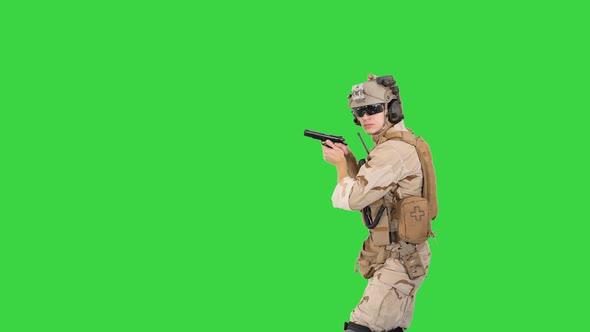 Soldier Walking Aiming with a Pistol and Shooting To Camera on a Green Screen, Chroma Key.