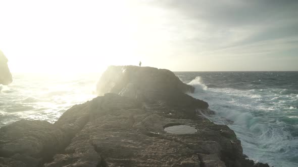 Couple Standing on the Top of Fungus Rock Islet - Limestone Lump in the Maltese Archipelago