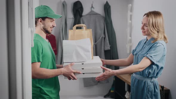 A Young Food Delivery Man in a Green Uniform