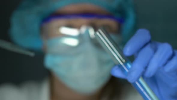 Lab Chemist Dripping Oil Into Test Tube With Blue Liquid Washing Substance Study