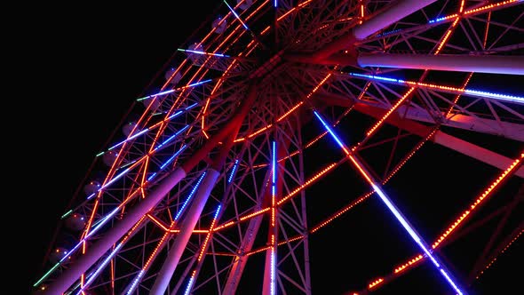 Ferris Wheel with Lights Rotates at Night