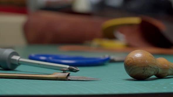 Closeup View of Work Tools Lying on Table Surface of Workshop