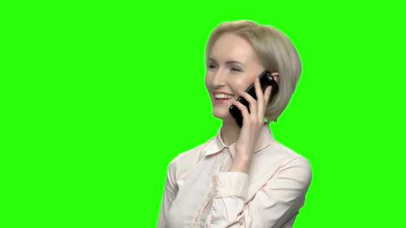 Happy Middle Aged Blond Woman Having Phone Conversation