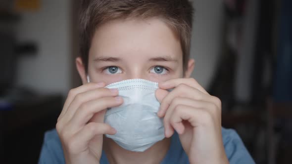 Teenager Puts a Protective Mask on His Face