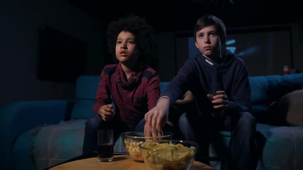 Scared Teens Eating Popcorn During Horror Movie