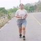 Fat Asian woman running, jogging outdoor at park. - VideoHive Item for Sale