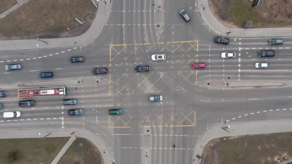 AERIAL: Cars Driving on a Street on a Rush Hour and Pedestrians Walking on Zebras