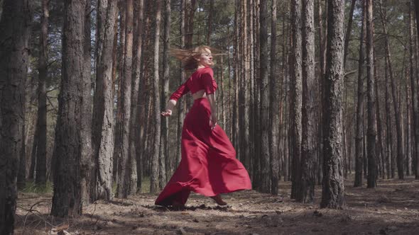 Experienced Pretty Young Woman in Red Dress Dancing in the Forest. Beautiful Dancer Dancing