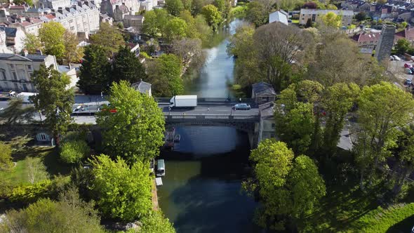 Aerial of a traffic laden road bridge in the centre of a beautiful and historical quaint english tow