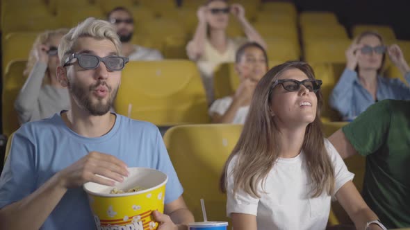 Group of People Putting on 3d Glasses and Watching Movie in Cinema. Portrait of Carefree Multiethnic