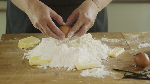 Woman in kitchen making dough for cookies