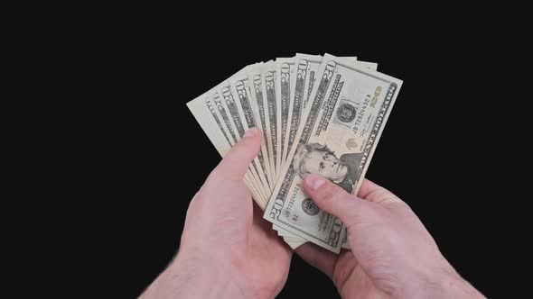 Male Hands Holding a Fan of a Lot of 20 Dollar Bills with Alpha Channel