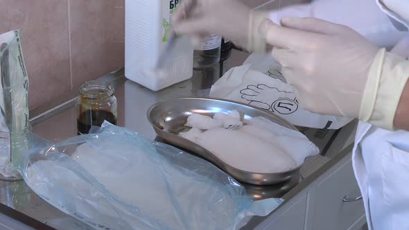 Doctor Video Footage - A Medical Practitioner Dipping A Cotton In A Solution For Wounds