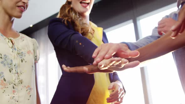 Businesspeople forming hands stack