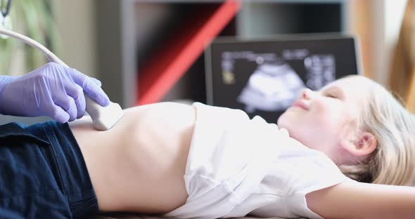 Doctor Conducting Ultrasound Examination of Internal Organs of Child in Clinic  Movie