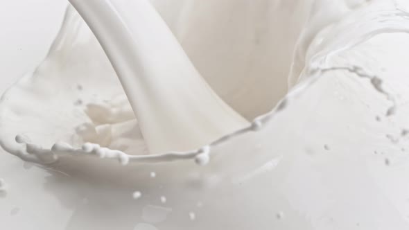 Super Slow Motion Detail Shot of Pouring and Splashing Fresh Cream at 1000 Fps