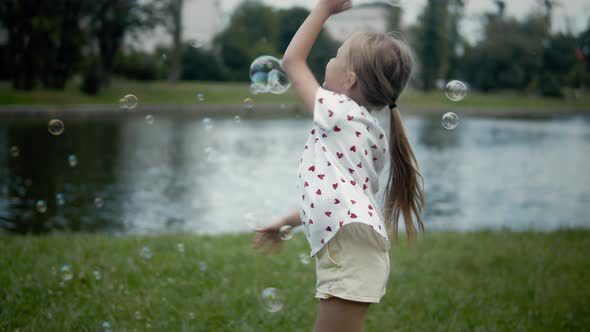 Little Girl Playing With Bubbles